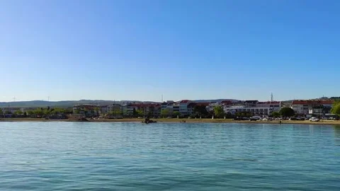 Panoramic View of Coastal Town Shoreline with Calm Blue Sea Water and Clear sky 스톡 동영상 345332900