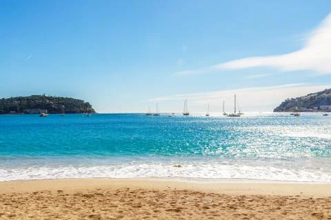 Panoramic view of coastline and beach with blue sky, luxury resort and bay wi Фото
