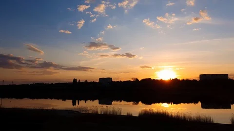 Panoramic view of colorful sunset clouds symmetric reflected on the lake surface Stock Footage 129250794