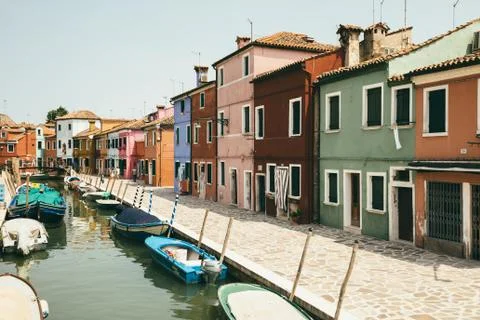 Panoramic view of coloured homes and water canal with boats in Burano Stock Photos