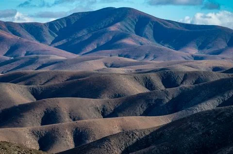 Panoramic view on colourful remote basal hills and mountains of Massif of B.. Stock Photos