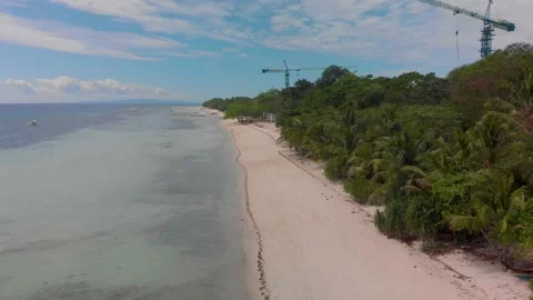 Panoramic view of the construction on a long sandy beach among the jungle Stock Footage 134943060