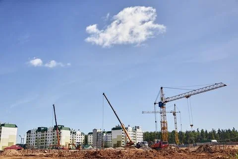 Panoramic view of construction sites and many cranes working Stock Photos