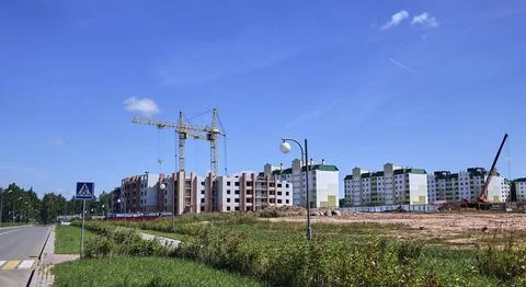 Panoramic view of construction sites and many cranes working Stock Photos