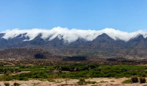 Panoramic view of the Cordillera of Bolivia. Clouds pour over mountain ranges Stock Photos