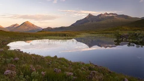 Panoramic view of Cuillin mountain range reflected in water Stock Photos