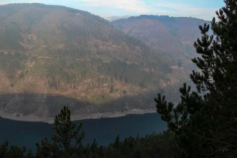 Panoramic view of a dam valley with pine trees in the foreground, Spain Stock Photos