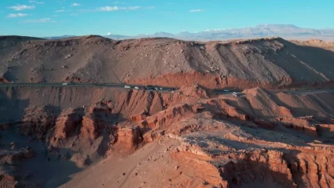 Panoramic view of a desert road with parked vehicles along the rim of layered Stock Footage 336266734