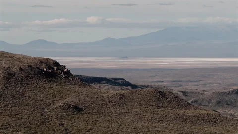 Panoramic view of desolate desert landscape with distant mountains under ov.. Stock Footage 337770593