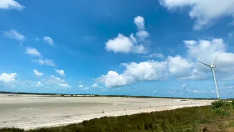 Panoramic view of a desolate sand plain and windmills stand with strong winds. Stock Footage 289566780