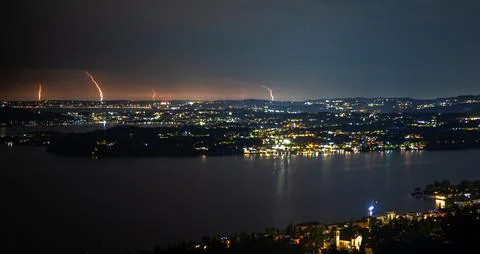 Panoramic view of distant lightning bolts at the horizon at Lake Garda, Italy Stock Photos