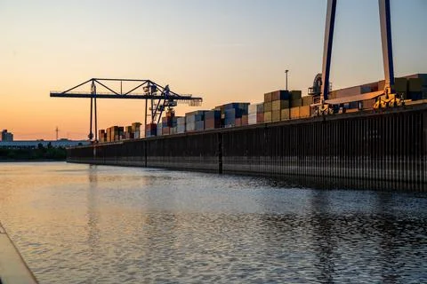 Panoramic view of the dock with containers and a crane in the background Stock Photos
