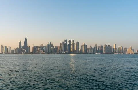 Panoramic view of Doha skyline across the Arabian Gulf in late afternoon, Qatar. Stock Photos