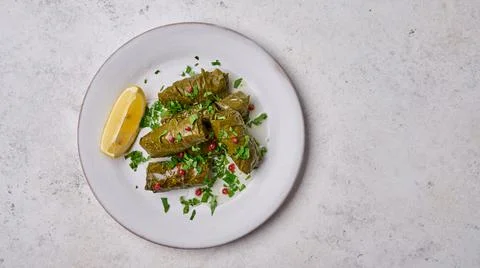 Panoramic view dolma, stuffed grape leaves with rice, meat, parsley, pepper and Stock Photos