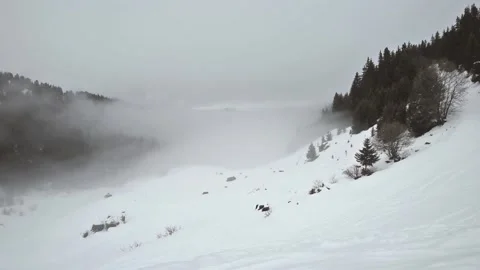 Panoramic view down a mountain valley with low clouds and overcast sky Stock Footage 194931043
