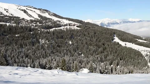 Panoramic view down a mountain valley range with ski resort village Stock Footage 194944146