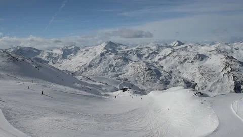 Panoramic view down a mountain valley range with ski piste Stock Footage 194990656