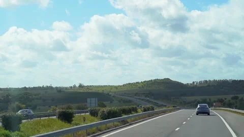 Panoramic view from driving on highway with green hills on the horizon Stock Footage 273674660