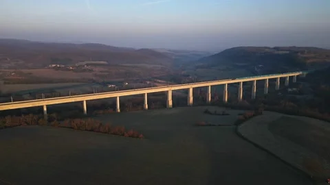 Panoramic view from a drone on passenger train crossing the railway flyover. Stock Footage 233198081