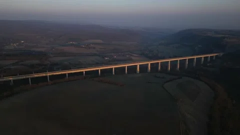 Panoramic view from a drone on passenger train crossing the railway flyover. 스톡 동영상 233263662