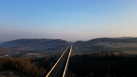 Panoramic view from a drone on passenger train crossing the railway flyover. 스톡 동영상 233263683