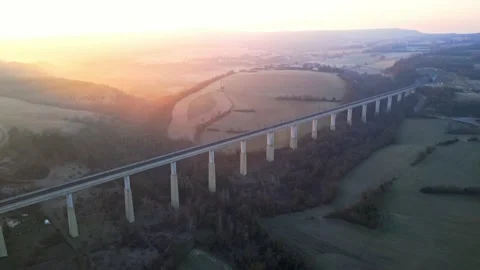 Panoramic view from a drone on passenger train crossing the railway flyover. Stock-Footage 233264038