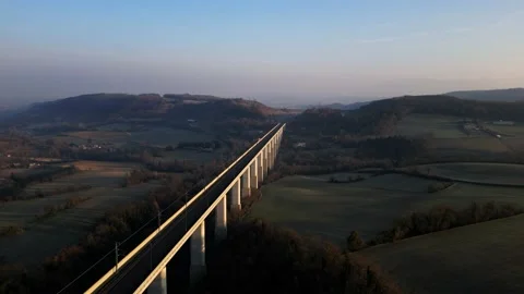Panoramic view from a drone on passenger train crossing the railway flyover. Stock-Footage 233264039