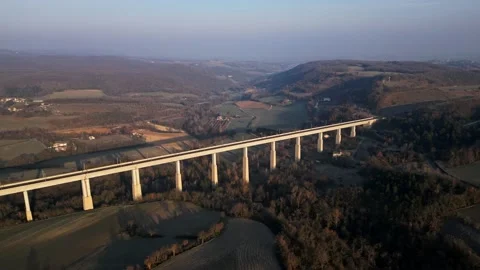 Panoramic view from a drone on passenger train crossing the railway flyover. Stock Footage 233264115