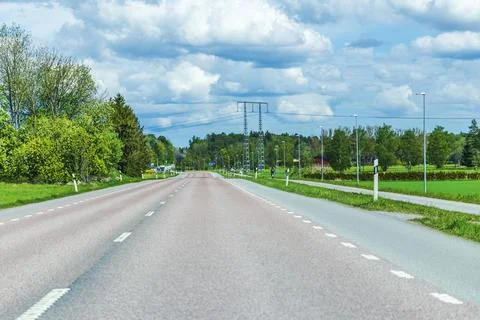Panoramic view of empty highway against background of cloudy sky. Sweden. Stock Photos