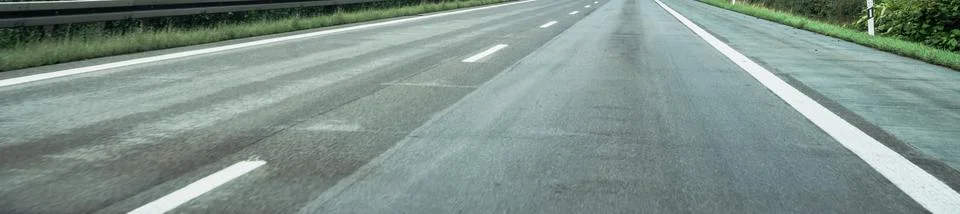 Panoramic view of an empty motorway with white lane markings stretching toward Stock Photos