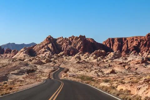 Panoramic view of endless winding empty road in Valley of Fire State Park l.. Stock Photos