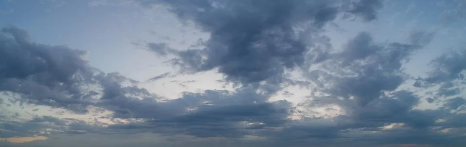 Panoramic view of evening sky with clouds, the sky at twilight. Stock Photos