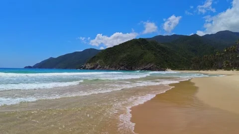 Panoramic view of the expansive beach at Choroni, with gentle waves and Видео 333362976