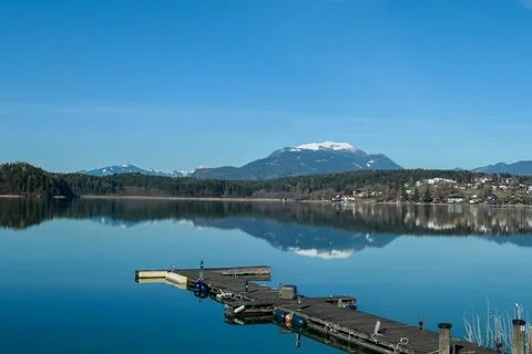 A panoramic view on the Faaker lake in Austrian Alps. The lake is surrounde.. Stock Photos