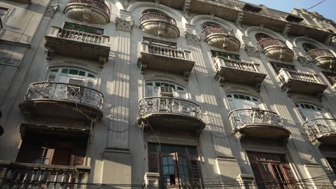 Panoramic view of facade of an old building with balconies in colonial style. El Stock Footage 244480517