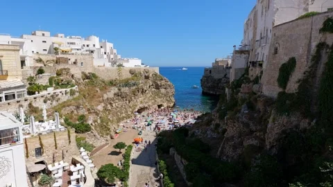 Panoramic view of the famous Polignano a Mare beach with vertical cliffs Stock Footage 315334961