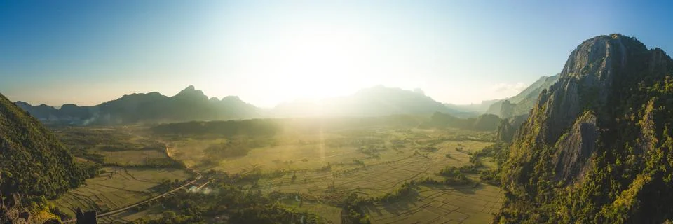 Panoramic view of farm fields and rock formations in Vang Vieng, Laos Stock Photos