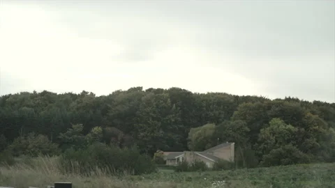 Panoramic view of a field with a house and trees behind it Video stock 221612846