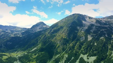 Panoramic view flight over the mountains covered with dense forest in summer day Stock Footage 114798190