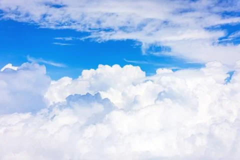Panoramic view of fluffy clouds on a summer day from the height of the plane. Fotos Stock