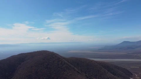 Panoramic View of Forested Hills and Hazy Valley. An expansive aerial shot .. Stock Footage 332004762