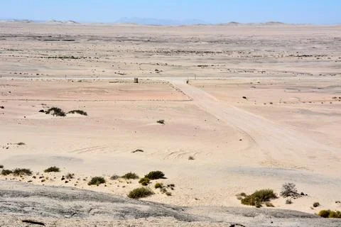 A panoramic view of a fork in a dirt road in a dry, hot desert. Arid climate Stock Photos