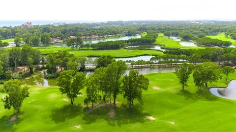 Panoramic view of a golf course with water features, sand traps, and distant Stock Photos