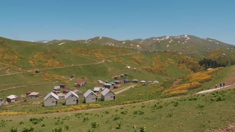 Panoramic view of Gomis Mta village featuring scattered houses, green hills Stock Footage 295207704