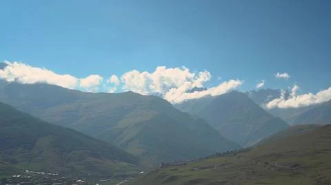 Panoramic view of the green cloudy Caucasus mountains. The camera moves from Stock Photos
