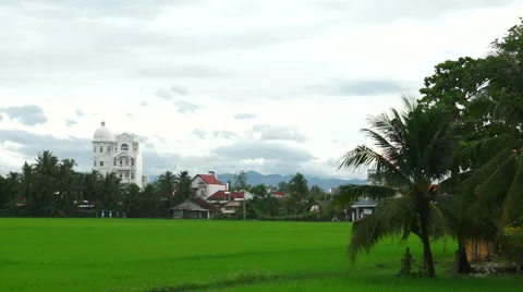 Panoramic view to green field, small houses of local habitants and beautiful Stock Footage 67426517