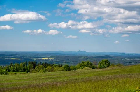 Panoramic view of green fields and forested hills near Jested, with the sha.. Stock Photos