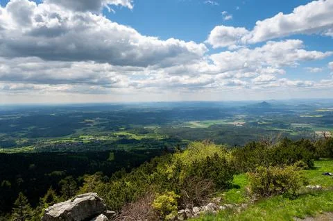 Panoramic view of green fields and forested hills near Jested, with the sha.. Stock Photos