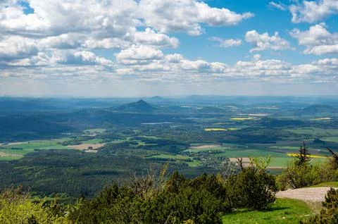 Panoramic view of green fields and forested hills near Jested, with the sha.. Stock-Fotos
