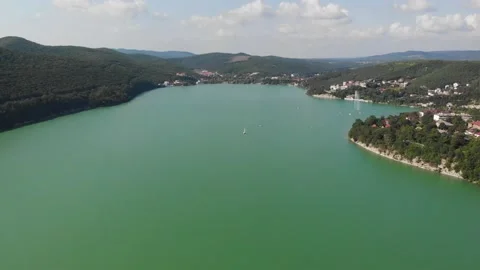 Panoramic view of the green lake from the drone. Mountains and forest around a Stock Footage 171108120